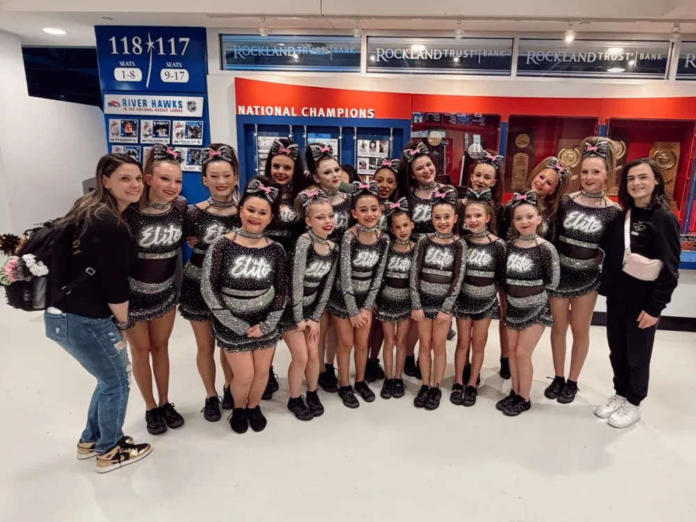 Coach Christin and the Elite Cheer team at a championship venue